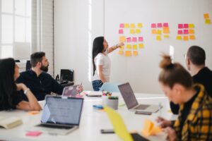 Student at whiteboard with post-it notes