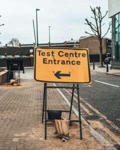 Sign that points to the left that says Test Centre Entrance