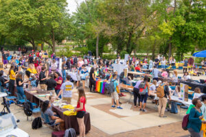 Students browse colorful tables to decide if they should join a college club.