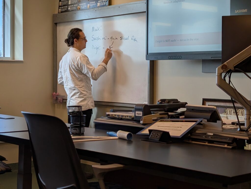 A chef writing on a dry-erase board