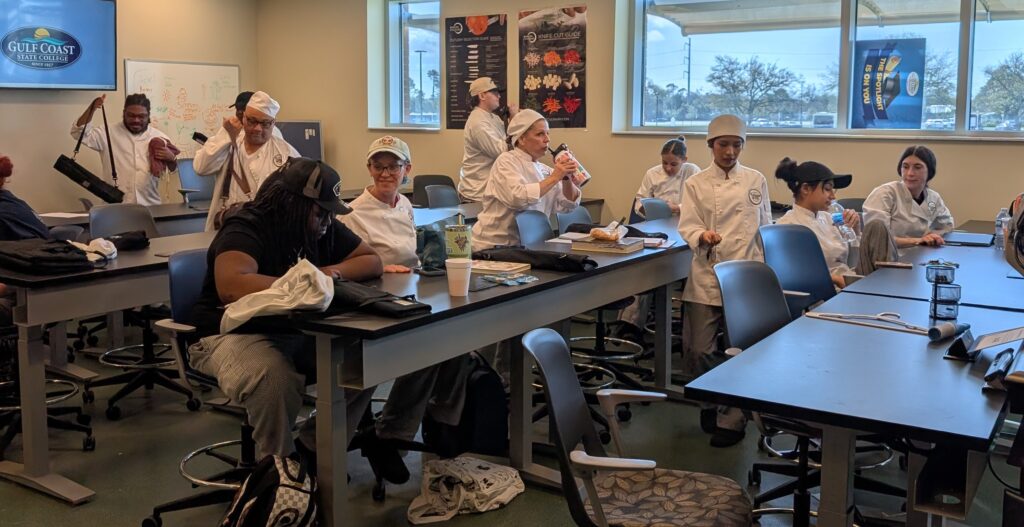 Students in a culinary classroom learning about sushi